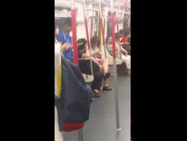 Woman on Hong Kong subway melts down when her phone battery dies.